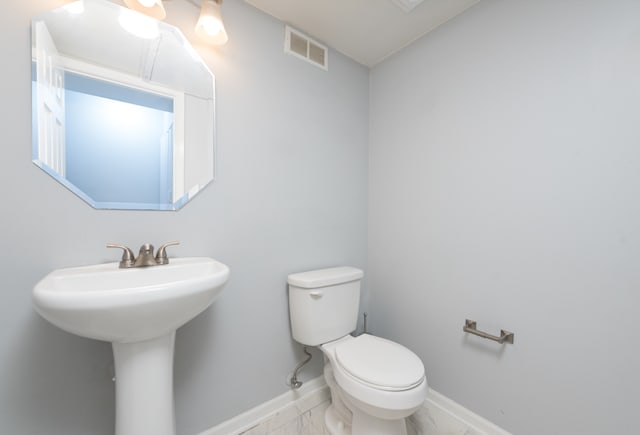 bathroom with toilet and sink