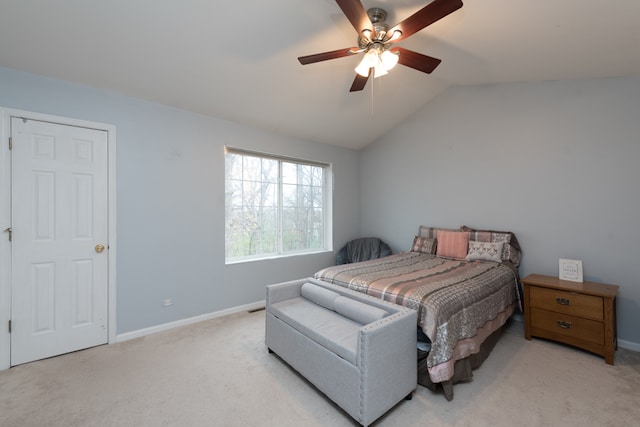 bedroom featuring ceiling fan, light colored carpet, and lofted ceiling