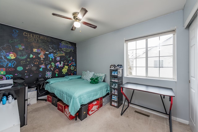 bedroom with a closet, ceiling fan, and light colored carpet