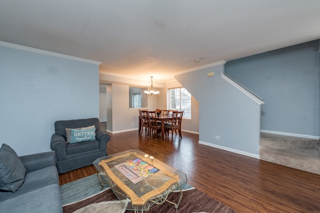 living room with crown molding, dark hardwood / wood-style flooring, and an inviting chandelier