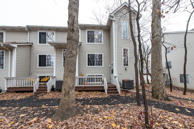 rear view of house featuring a wooden deck and central air condition unit