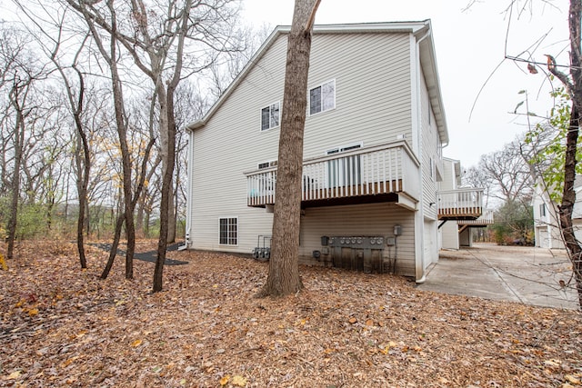 back of property featuring a deck and a patio area