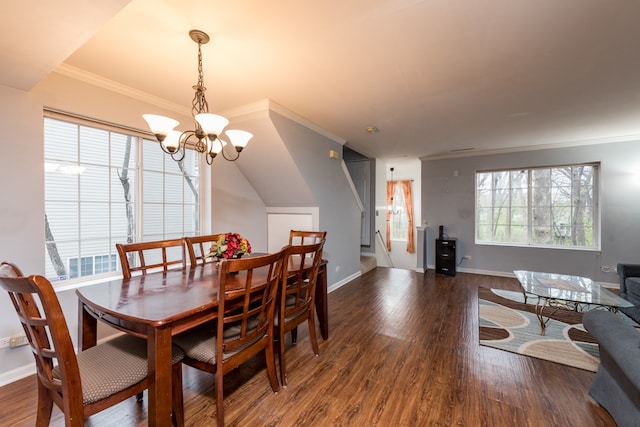 dining space with a chandelier, crown molding, and dark wood-type flooring