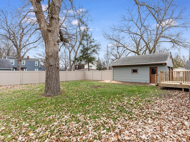 view of yard featuring an outdoor structure and a deck