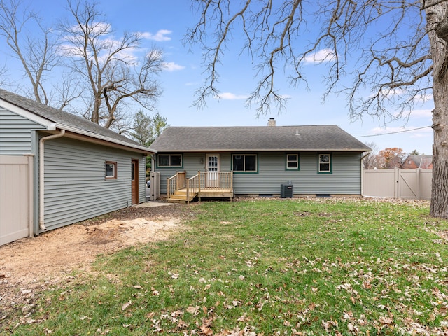 rear view of property featuring a lawn, cooling unit, and a deck