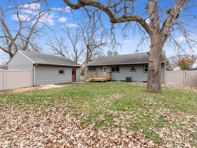 back of property featuring a wooden deck, a yard, and cooling unit