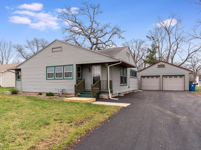 view of front facade featuring a garage, an outdoor structure, and a front yard