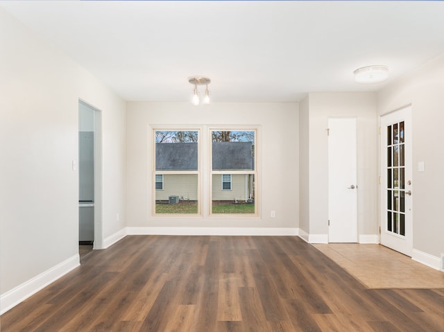 spare room with dark wood-type flooring