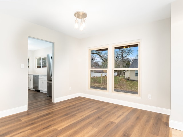 interior space with dark hardwood / wood-style floors and an inviting chandelier