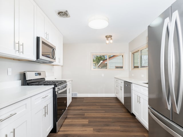 kitchen featuring white cabinetry, dark hardwood / wood-style floors, and appliances with stainless steel finishes