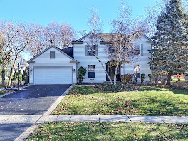 front of property featuring a front yard and a garage