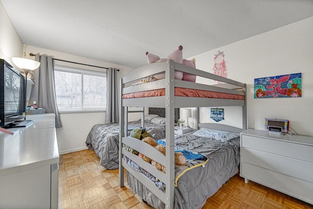 bedroom with light parquet flooring