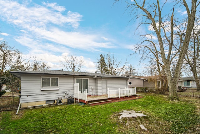 back of property with a yard and a deck