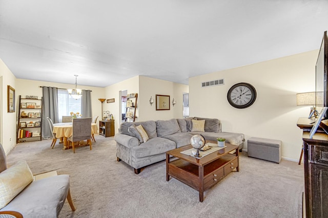 living room featuring an inviting chandelier and light colored carpet