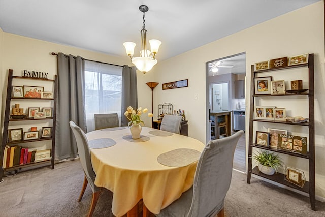 dining room featuring a notable chandelier and light colored carpet