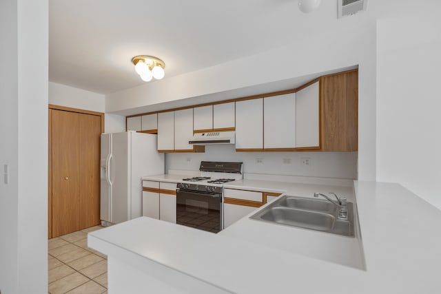 kitchen with white cabinets, white appliances, light tile patterned flooring, and sink