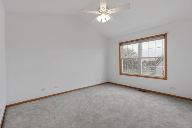 empty room featuring ceiling fan, carpet, and vaulted ceiling