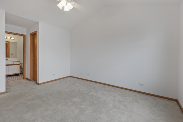 carpeted spare room with ceiling fan and lofted ceiling