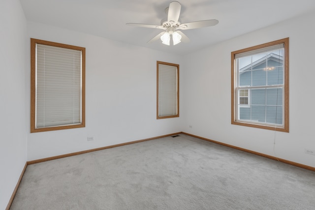 carpeted empty room featuring ceiling fan