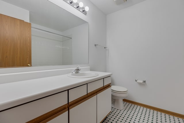 bathroom with tile patterned flooring, vanity, and toilet