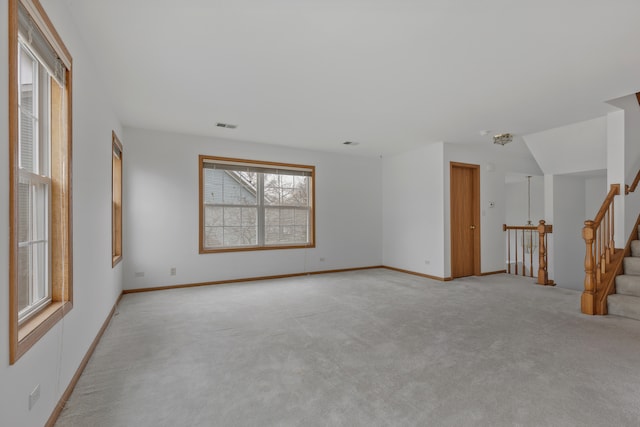 unfurnished living room featuring light colored carpet