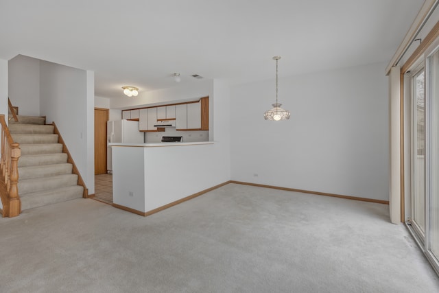 unfurnished living room with light colored carpet