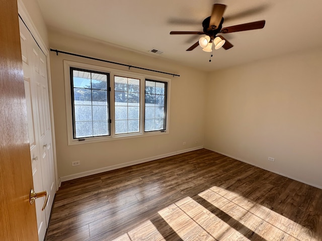 empty room featuring wood-type flooring and ceiling fan