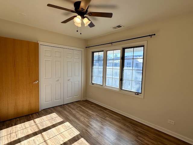 unfurnished bedroom with a closet, ceiling fan, and hardwood / wood-style floors