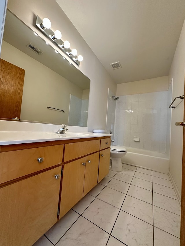 full bathroom with tiled shower / bath, vanity, and toilet