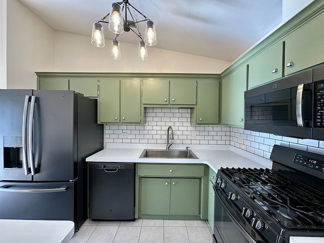 kitchen with backsplash, vaulted ceiling, sink, black appliances, and green cabinetry