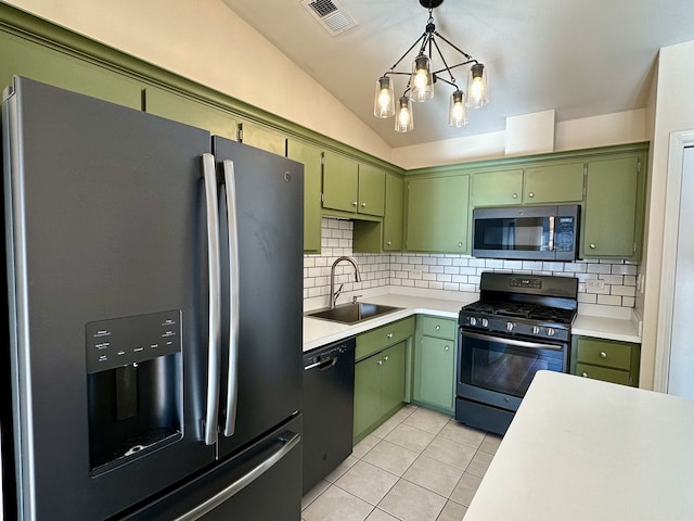 kitchen featuring lofted ceiling, green cabinets, sink, tasteful backsplash, and stainless steel appliances