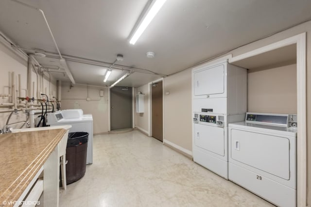 laundry room featuring stacked washer / drying machine and washer and clothes dryer