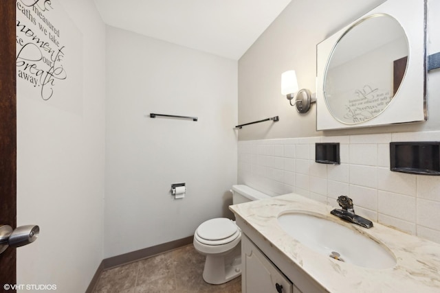 bathroom with vanity, tile walls, tile patterned floors, and toilet