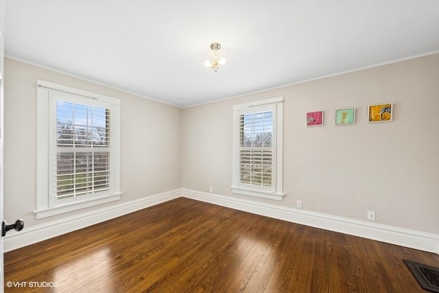 spare room with ornamental molding, hardwood / wood-style flooring, and a healthy amount of sunlight