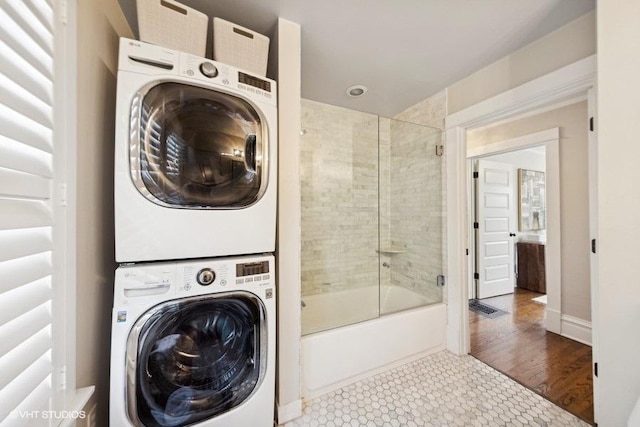 washroom featuring stacked washer / dryer and hardwood / wood-style floors