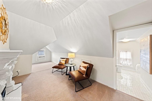 living area with a wealth of natural light, light carpet, and lofted ceiling