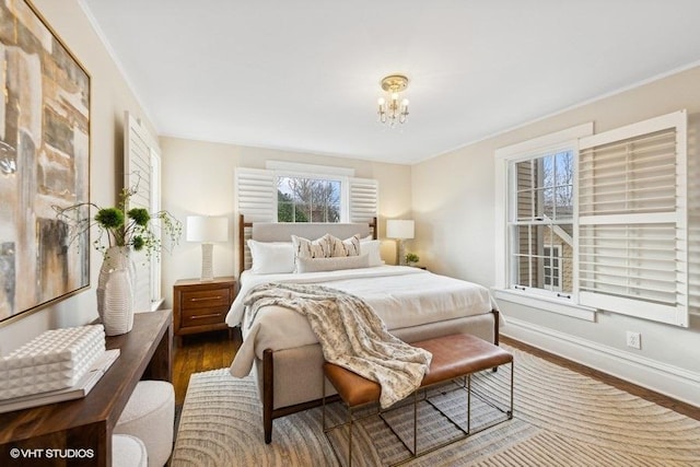 bedroom featuring dark wood-type flooring and a notable chandelier