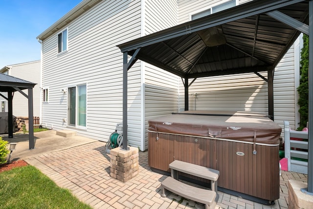 view of patio / terrace with a gazebo and a hot tub