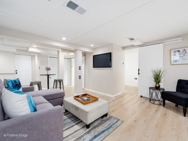 living area featuring recessed lighting, visible vents, light wood-style flooring, and baseboards