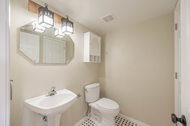 bathroom with tile patterned floors, toilet, and sink