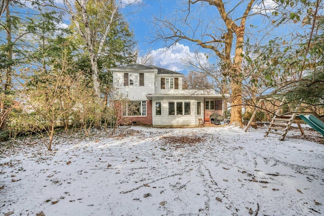 view of snow covered rear of property