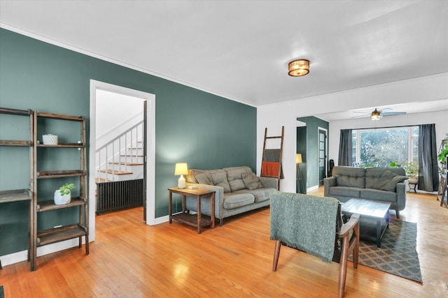 living room with radiator, ceiling fan, and light hardwood / wood-style floors