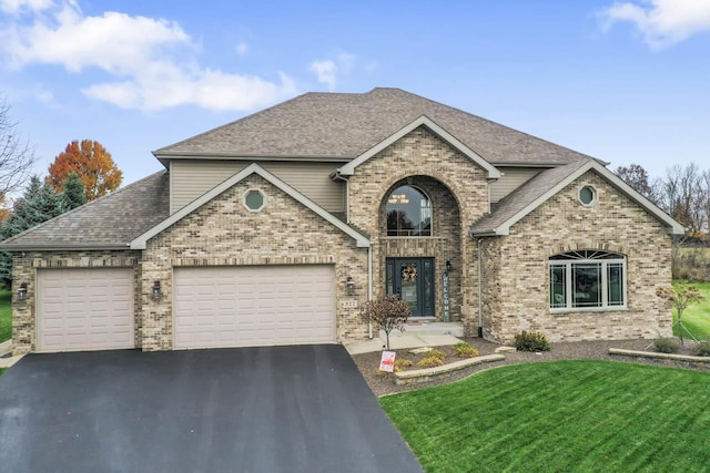 view of front of home featuring a garage and a front yard