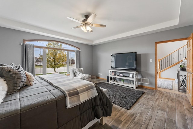 bedroom with a tray ceiling and ceiling fan