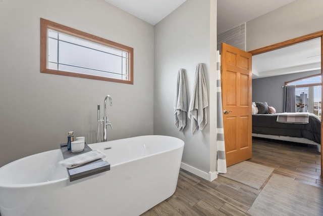 bathroom with a tub and plenty of natural light