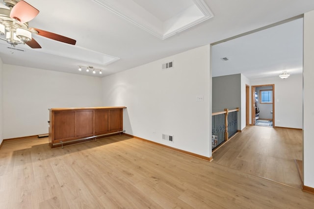 empty room with ceiling fan and light hardwood / wood-style flooring