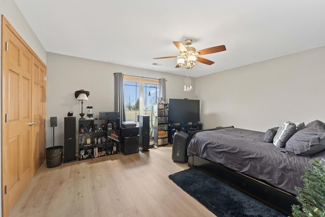 bedroom with light hardwood / wood-style flooring and ceiling fan