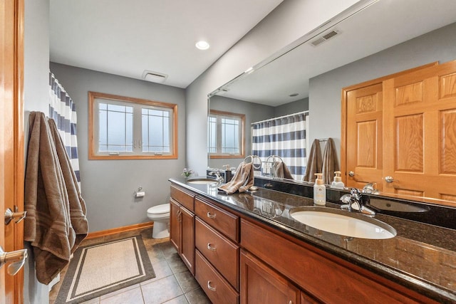 bathroom featuring a shower with shower curtain, tile patterned floors, vanity, and toilet