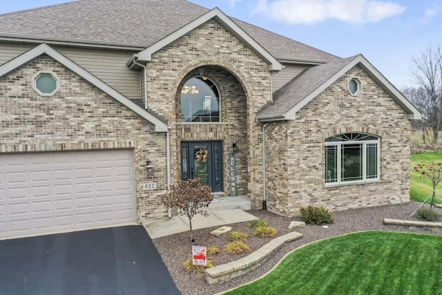 view of front of home featuring a garage and a front lawn