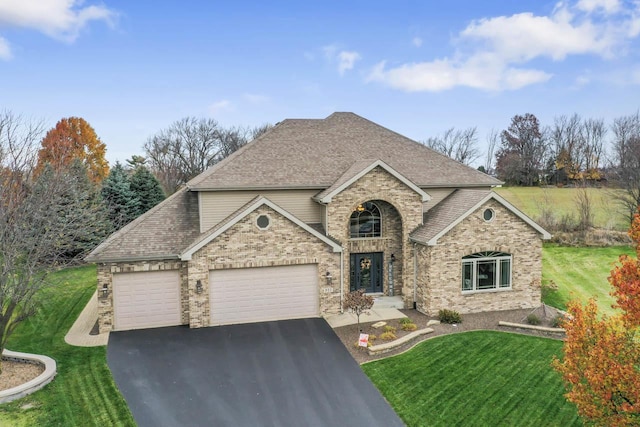 view of front of property featuring a front yard and a garage